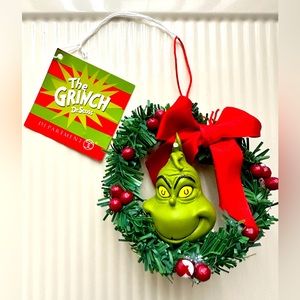Dept 56 Grinch Ornament.  Never used, but is blemished.